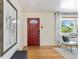 Stylish entryway featuring hardwood floors, a red door, and a window with a view at 5593 E Center Ave, Denver, CO 80246