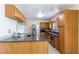Open kitchen with granite counters, stainless steel appliances, and modern lighting at 5593 E Center Ave, Denver, CO 80246