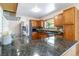 Kitchen features a large center island, granite countertops, and stainless appliances at 5593 E Center Ave, Denver, CO 80246