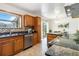 Open kitchen with stainless steel appliances and hardwood floors at 5593 E Center Ave, Denver, CO 80246