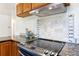 Kitchen features modern appliances and dark granite countertops at 5593 E Center Ave, Denver, CO 80246