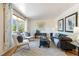 Bright living room featuring a comfortable sofa, stylish decor, and a bay window at 5593 E Center Ave, Denver, CO 80246