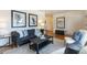 Comfortable living room featuring a sofa, stylish decor, and hardwood floors at 5593 E Center Ave, Denver, CO 80246