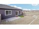 This backyard has a rock garden, artificial lawn, and concrete patio at 17673 Brass Buckle Way, Monument, CO 80132