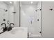 Bright bathroom featuring a glass-enclosed shower, modern fixtures, and sleek design at 17673 Brass Buckle Way, Monument, CO 80132