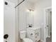 Stylish bathroom featuring a sleek mirror, modern vanity, and subway-tiled shower with black accents at 17673 Brass Buckle Way, Monument, CO 80132