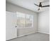Minimalist bedroom with a gray carpet, large window with blinds, and a modern ceiling fan at 17673 Brass Buckle Way, Monument, CO 80132
