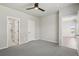 Spacious bedroom with gray carpet, bright white doors, and ensuite bathroom with shower and toilet at 17673 Brass Buckle Way, Monument, CO 80132