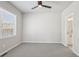 Bright bedroom featuring neutral walls, plush carpeting, ceiling fan and a connected bathroom at 17673 Brass Buckle Way, Monument, CO 80132