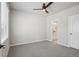 Bedroom with view to a bathroom and window with blinds for natural light at 17673 Brass Buckle Way, Monument, CO 80132