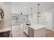 Bright kitchen with island, pendant lights, stainless steel appliances, and view to the backyard at 17673 Brass Buckle Way, Monument, CO 80132
