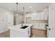 Modern kitchen featuring an island with pendant lighting, white cabinets, and stainless steel appliances at 17673 Brass Buckle Way, Monument, CO 80132