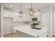 Bright kitchen with white cabinets, quartz countertops, stainless steel appliances, and contemporary pendant lighting at 17673 Brass Buckle Way, Monument, CO 80132