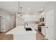 Spacious kitchen featuring white cabinets, stainless steel appliances, quartz countertops, and pendant lighting at 17673 Brass Buckle Way, Monument, CO 80132