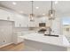 Stylish kitchen featuring white cabinets, quartz countertops, stainless steel appliances, and decorative pendant lights at 17673 Brass Buckle Way, Monument, CO 80132
