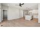 Bright living room with open layout to the kitchen, light wood floors, and modern fixtures at 17673 Brass Buckle Way, Monument, CO 80132