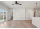 Open-concept living room with light wood floors, neutral walls, modern lighting, and access to the backyard at 17673 Brass Buckle Way, Monument, CO 80132