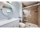 Updated bathroom features a glass shower door, vanity, sink and round mirror at 2904 S Idalia St, Aurora, CO 80013