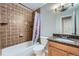 This bathroom features tiled shower, tub, vanity with granite countertop, and soft lighting at 2904 S Idalia St, Aurora, CO 80013