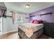 Cozy bedroom features wood floors, bright window, closet and accent wall with shelving at 2904 S Idalia St, Aurora, CO 80013