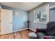 Bedroom with wood floors features a large window, chair, and closet at 2904 S Idalia St, Aurora, CO 80013