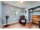 This bedroom with wood floors features a recliner chair and window with natural light at 2904 S Idalia St, Aurora, CO 80013