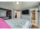 Bedroom includes closet, tv on wall, and connected bathroom with standing shower at 2904 S Idalia St, Aurora, CO 80013