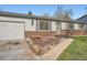 Inviting single-story home with a well-kept flower bed, brick accents, and an attached garage at 2904 S Idalia St, Aurora, CO 80013