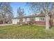Inviting single-story home with a well-kept lawn, brick accents, and an attached garage on a sunny day at 2904 S Idalia St, Aurora, CO 80013