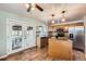 Well-lit kitchen with stainless steel appliances, wooden cabinets, and access to the deck at 2904 S Idalia St, Aurora, CO 80013