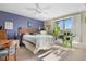 Sun-filled bedroom with a modern bed frame, calming purple wall, and mountain views at 8612 S Everett Ct, Littleton, CO 80128