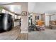 Bright living room and kitchen featuring light wood floors and a cozy sitting area at 8612 S Everett Ct, Littleton, CO 80128