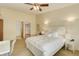 Inviting bedroom with soft lighting, white furniture, and a glimpse into a closet space at 625 S Alton Way # 10D, Denver, CO 80247