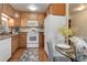 Bright kitchen featuring wood cabinets and adjacent appliances with dining area at 625 S Alton Way # 10D, Denver, CO 80247
