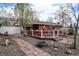 Charming backyard features mature trees, a spacious deck, and stone walkway, perfect for entertaining at 1425 S Newport St, Denver, CO 80224