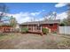 Backyard featuring a well-maintained lawn, a deck with railing, and a privacy fence at 1425 S Newport St, Denver, CO 80224