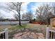Large backyard featuring decorative stone pavers, a white fence, and mature trees at 1425 S Newport St, Denver, CO 80224