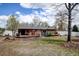 Large backyard with deck, lush lawn, mature trees, and a privacy fence offer lots of room to play at 1425 S Newport St, Denver, CO 80224