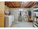 Unfinished basement with laundry area, extra storage space and room for customization at 1425 S Newport St, Denver, CO 80224