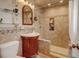 Updated bathroom with tiled walk-in shower, mosaic accents, and storage niche at 1425 S Newport St, Denver, CO 80224
