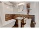 Bright bathroom with modern fixtures including a pedestal sink and soaking tub at 1425 S Newport St, Denver, CO 80224