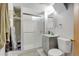 Modern bathroom with a glass-enclosed shower, gray vanity, and white subway tile at 1425 S Newport St, Denver, CO 80224