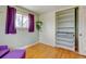 Well-lit bedroom features hardwood floors, a closet, and purple curtains at 1425 S Newport St, Denver, CO 80224