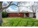 Charming brick ranch home with a well-maintained lawn and mature tree at 1425 S Newport St, Denver, CO 80224