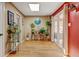Bright hallway with natural light, wood floors, and decorative plants at 1425 S Newport St, Denver, CO 80224