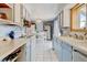 Bright kitchen featuring blue and white cabinetry with a view to the dining area at 1425 S Newport St, Denver, CO 80224