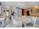 Kitchen featuring white cabinets, blue accents, and a cozy dining area at 1425 S Newport St, Denver, CO 80224