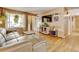 Inviting living room with hardwood floors, large windows, and a modern entertainment center at 1425 S Newport St, Denver, CO 80224