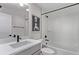 Bathroom featuring vanity with white countertop, white subway tile, a shower-tub, and matte black fixtures at 14998 Cast Pebble Cir, Parker, CO 80134