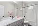 Bathroom featuring vanity with white countertop, white subway tile, a shower-tub, and matte black fixtures at 14998 Cast Pebble Cir, Parker, CO 80134